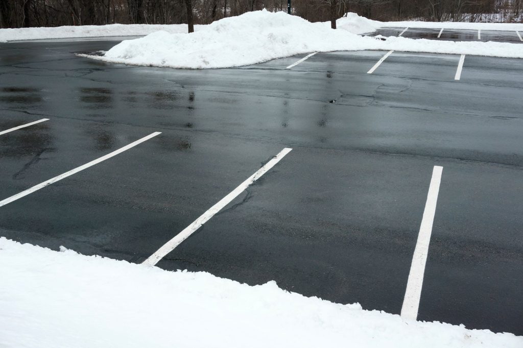 Parking lot cleanup efforts after snowfall
